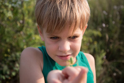 Cute girl with insect on hand