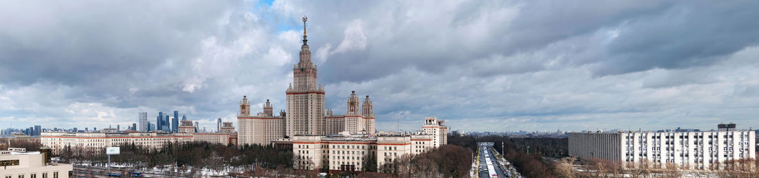 Wide angle panorama of spring campus of famous university in moscow under dramatic cloudy sky