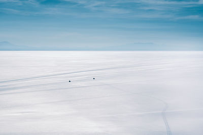 Scenic view of salt flat at salar de uyuni against cloudy sky