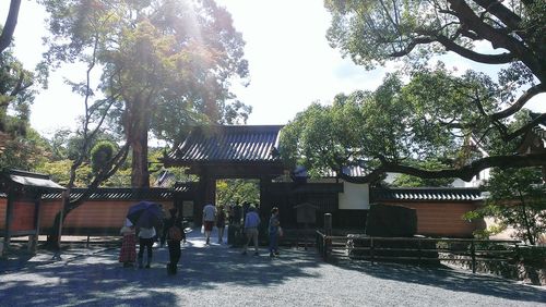 People at temple against sky