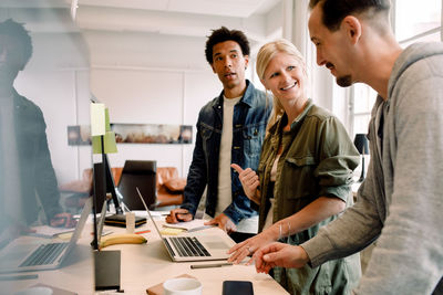 Businesswoman talking in meeting with male colleagues in office