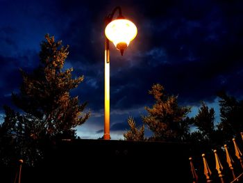 Low angle view of illuminated street light against sky at night