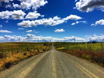 Empty road along countryside landscape