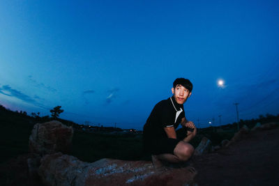 Full length of man sitting at night