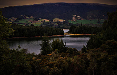 Scenic view of lake and mountains against sky