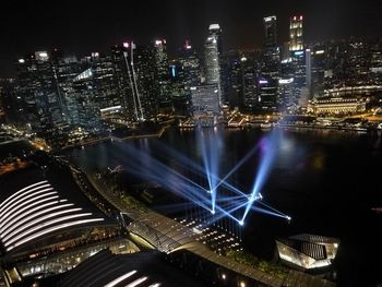 Illuminated cityscape against sky at night