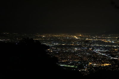 High angle view of illuminated buildings against sky at night