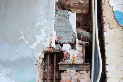 Damaged building seen through broken window