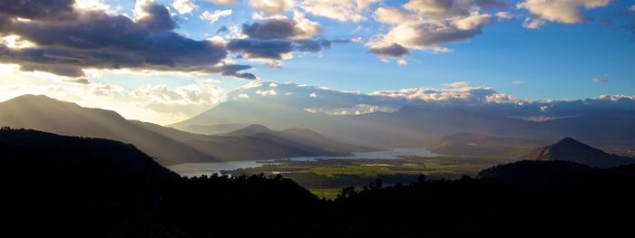 Scenic view of silhouette mountains against sky during sunset