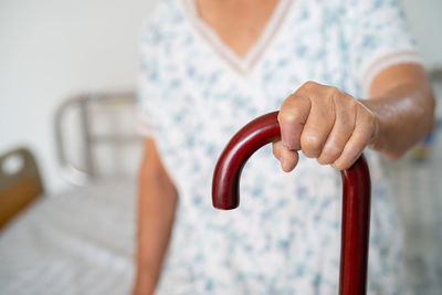 Midsection of woman holding handle at home