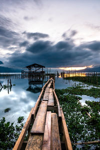 Pier over lake against sky