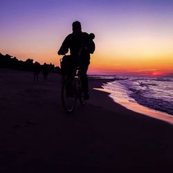 Silhouette of woman on beach at sunset