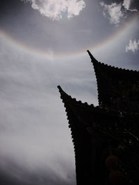 Low angle view of building against cloudy sky