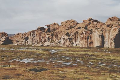 Rock formations on landscape against sky