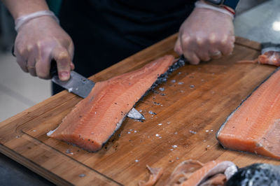 Cropped image of man working on cutting board