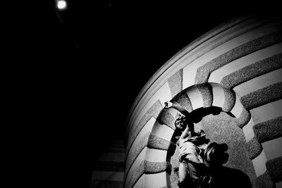 Reflection of woman on wall in illuminated building