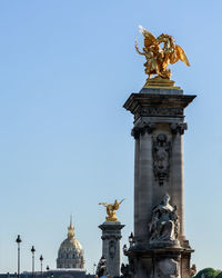 Statue in paris against clear sky