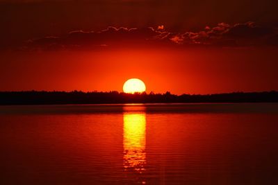 Scenic view of lake against romantic sky at sunset