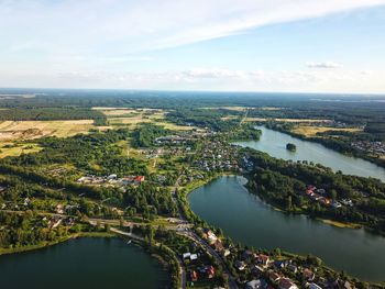 High angle view of river amidst cityscape against sky