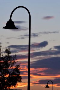 Silhouette trees against sky during sunset