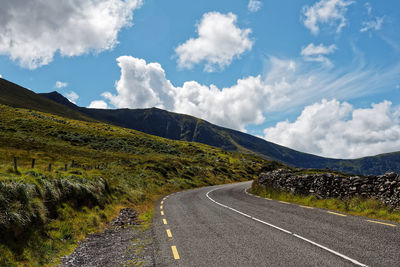 Road amidst mountains against sky