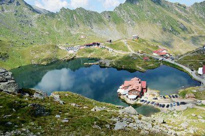 High angle view of lake and mountains against sky