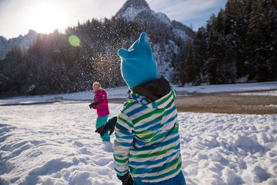 Rear view of girl on snow covered land