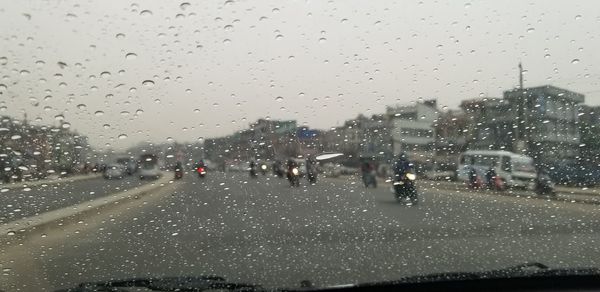 City seen through wet glass window