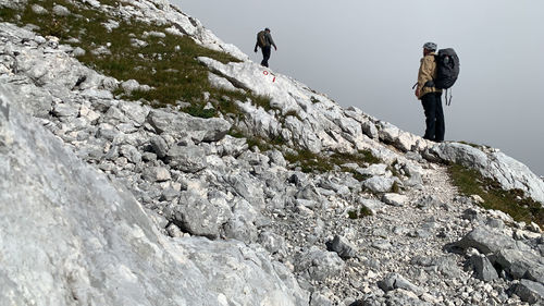 People standing on rock by mountain