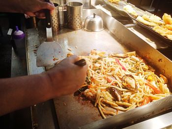 Midsection of person preparing food in kitchen