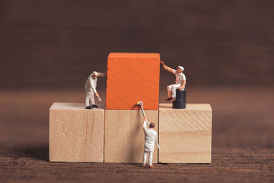 Close-up of figurines and wooden blocks on table