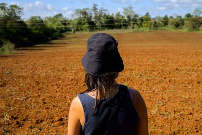 Rear view of woman standing on field