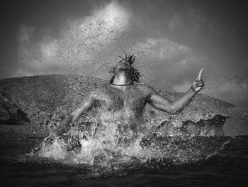 Woman swimming in sea against sky