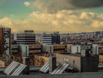 High angle view of barcelona cityscape against cloudy sky