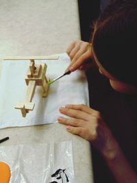 High angle view portrait of girl holding hands at home