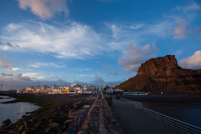 Road by sea against sky in city