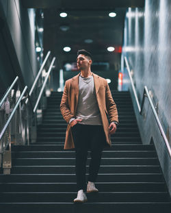 Full length of man standing on staircase