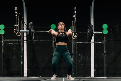 Full length of woman weightlifting in gym