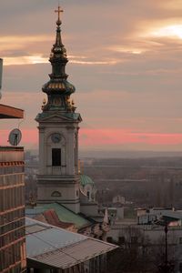 Aerial view of buildings in city during sunset