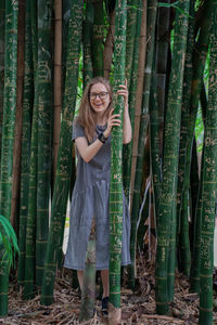 Full length of woman standing on bamboo structure