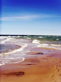 Scenic view of beach against blue sky