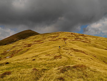 Scenic view of landscape against cloudy sky