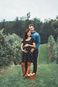 Full length of couple standing on field
