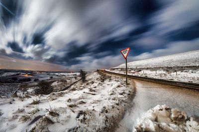 Snow covered landscape against sky