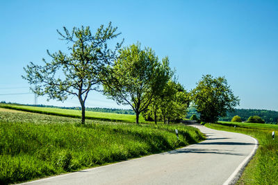 Scenic view of rural landscape against clear blue sky