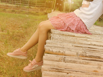 Low section of woman sitting outdoors