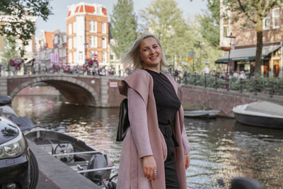 Portrait of a smiling young woman in the street of amsterdam