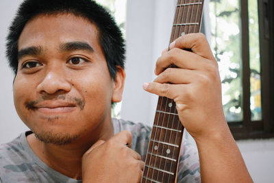 Close-up of man playing guitar