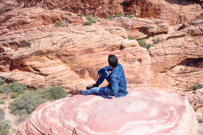 Man sitting on rock