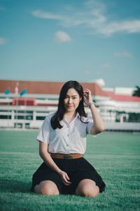 Portrait of a smiling young woman sitting outdoors